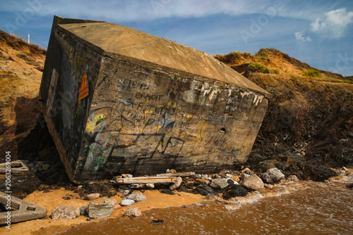 Obraz na plátně Historical concrete military bunker tilted on the sandy shore of Plage de Sauvet