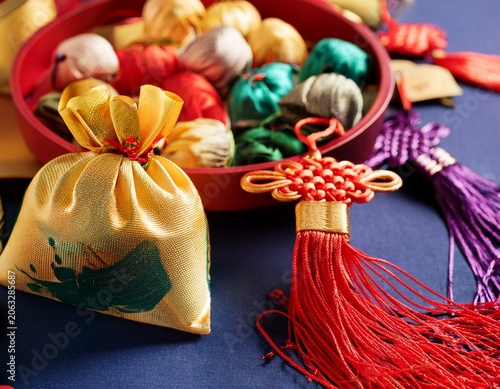 dragon boat festival traditional sachet and colorful silk thread oriental background