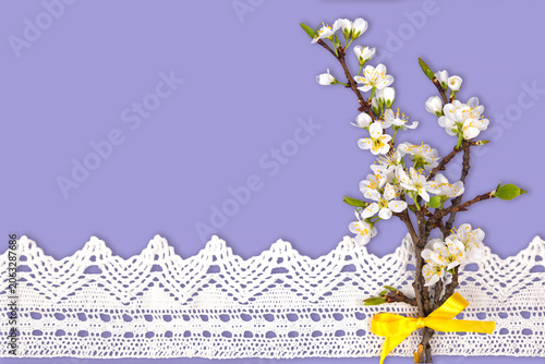 Spring Blossoms Arranged With White Lace and Yellow Ribbon Create a Simple Decor for Any Home Setting This Season