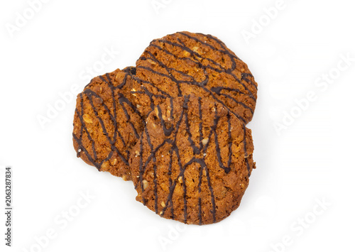 Three Cookies With Chocolate Drizzle Arranged on a White Background During a Bright Daylight Setting