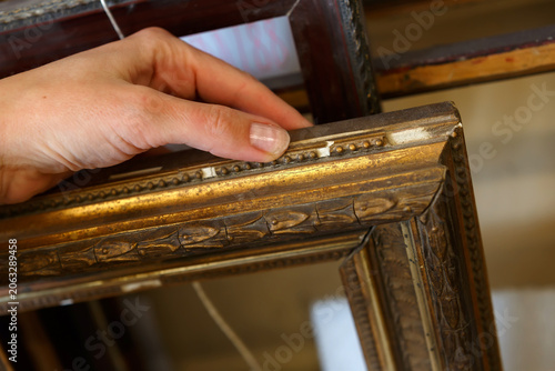Hand Reaching for a Frame in an Art Shop During the Afternoon
