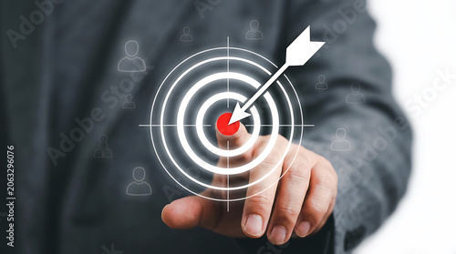 Man in suit touching digital target graphic symbolising business strategic vision and management