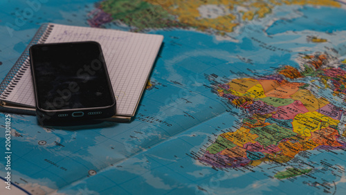 Planning a trip with travel accessories on a world map