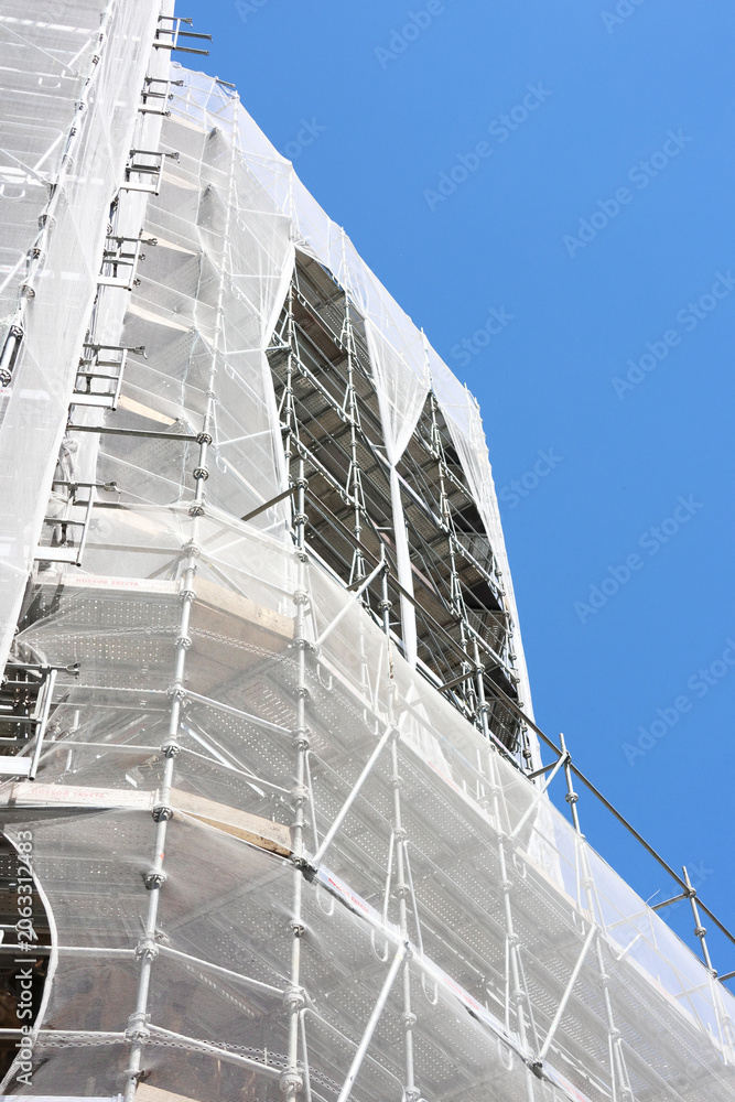 Fototapeta premium Urban Construction Project with Scaffolding for Modern Building Renovation