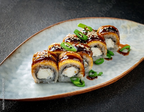 gourmet unagi sushi rolls topped with glazed eel and green onions