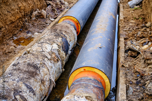 Obraz na plátne Old corroded heating pipelines being replaced with modern pre-insulated pipes in