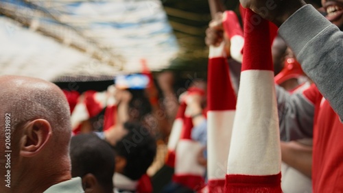 Cuadro en lienzo Organized fan club waving scarves celebrating in the terrace stands, thrilling football match in a crowded stadium, Active fans create synchronized fan chants