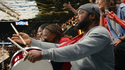 Schilderij op canvas Tense soccer fans watching decisive moment during live football match in stadium filled with suspense and anticipation, Worried fans holding breath during crucial penalty kick, serious crowd