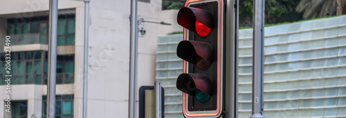 Obraz na płótnie Red traffic light illuminated on a signal, indicating stop for vehicles, symbolizing road safety, traffic control, and regulated urban transportation flow at intersections