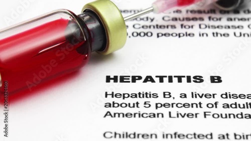 Hepatitis B Vaccine and Syringe on Medical Document Close-Up