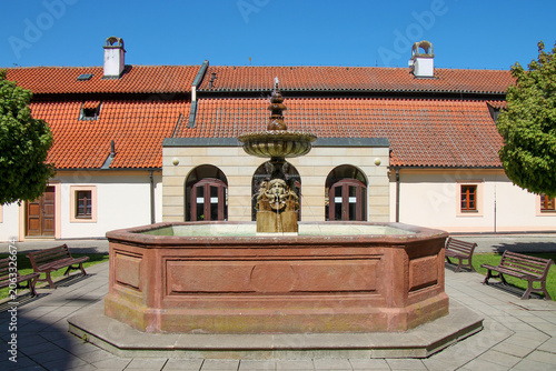  view of a beautiful fountain on a summer day in the castle courtyard in the spa town of Podebrady, Czech Republic.