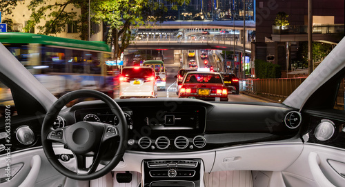 Night cityscape viewed from a modern car interior
