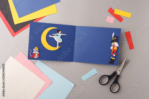 Paper cut out Nutcracker ballet character scene on blue background. Perfect for theater marketing, kids art school promotion, winter holiday greetings, handicraft workshop advertising