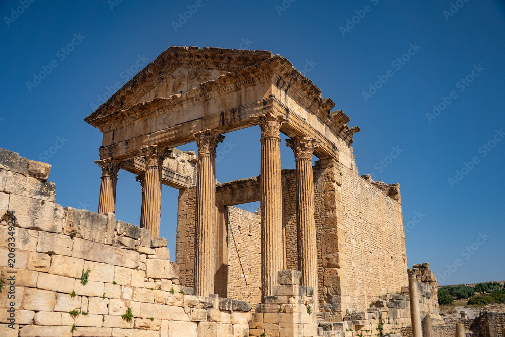 Obraz premium The Capitol in the Roman ruins of Dougga, in Northern Tunisia