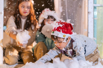 Smiling girl hugs a soft teddy bear gift beside the Christmas tree during a joyful family holiday celebration.