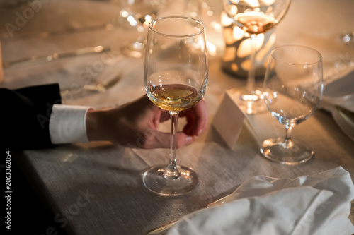 Photos Partially Filled White Wine Glass on Elegant Candlelit Reception Table Creating