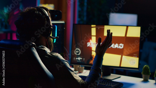 Bild auf Leinwand Sad gamer upset after losing online multiplayer action video game championship, being defeated by rivals, man putting face in palms in frustration after seeing game over screen on gaming PC display
