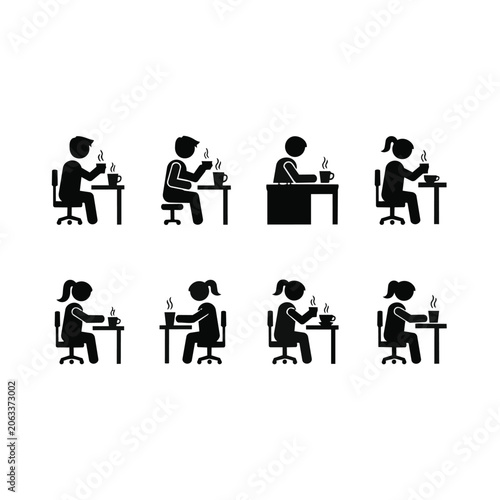 People sitting at desks working on computers in office setting.