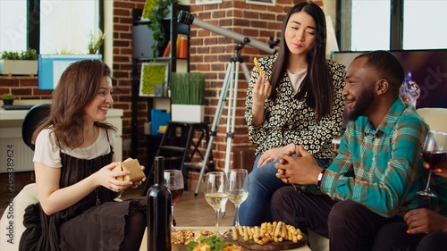 Foto Multiethnic mates invited to birthday party offering presents to happy asian host impressed by nice gesture