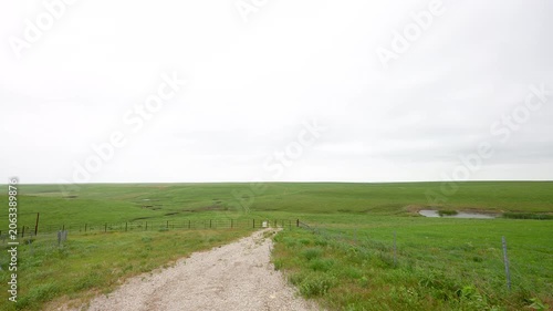 a Flint Hills gravel road leads to a prime ranch land cattle pasture