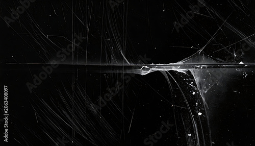 Abstract dark distressed texture overlay with film scratches and dust particles in monochromatic black and white, dramatic cinematic film effect