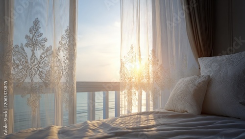 Sunrise view through sheer curtains, onto a balcony overlooking the sea. Soft morning light