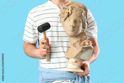Young male sculptor with cl...