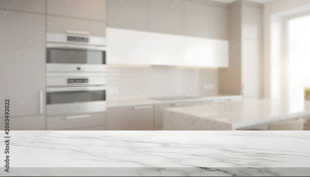 Fototapeta premium White marble tabletop in front of blurred modern kitchen interior with built-in appliances and beige cabinets for product display background