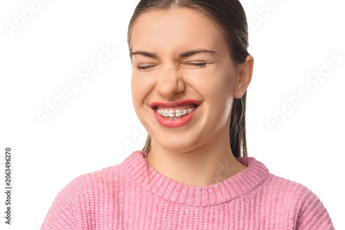 Εκτύπωση καμβά Beautiful young woman with dental braces suffering from pain on white background