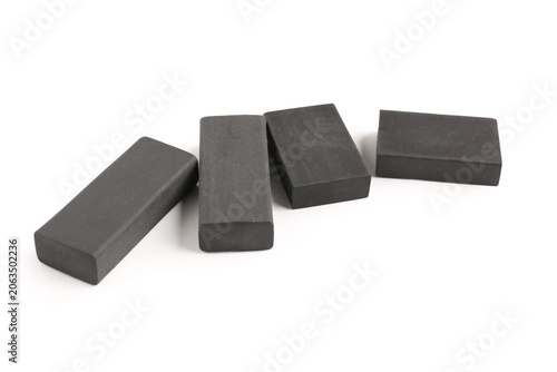 Black rubber erasers on whi...
