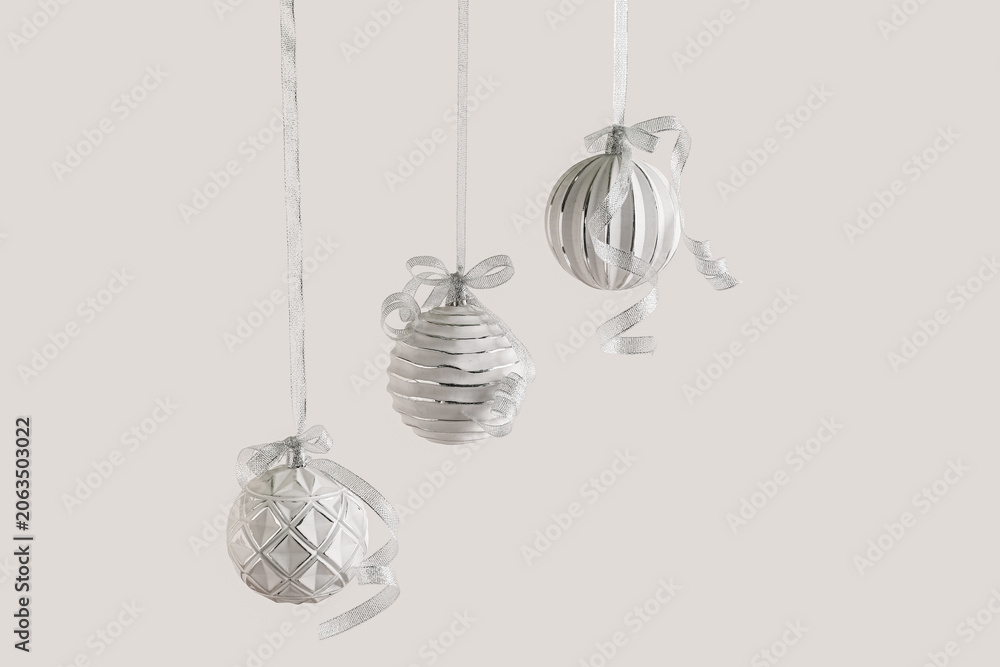 Fototapeta premium Christmas balls hanging on white background