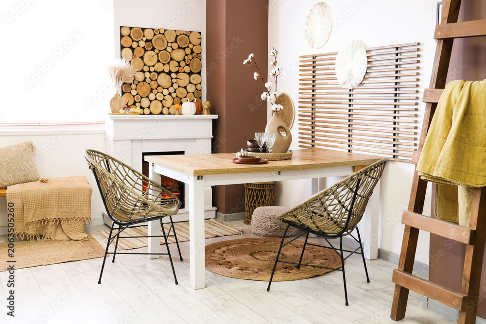 Obraz premium Interior of stylish dining room with table, fireplace and ladder