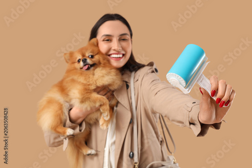 Young woman with lint rolle...