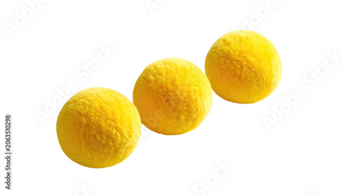 Three fluffy, yellow orbs with a textured surface float in a diagonal arrangement against a stark black background