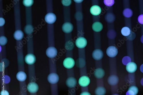 A bunch of green and blue lights on a black background