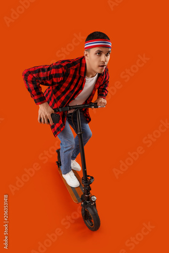 Young man with kick scooter...