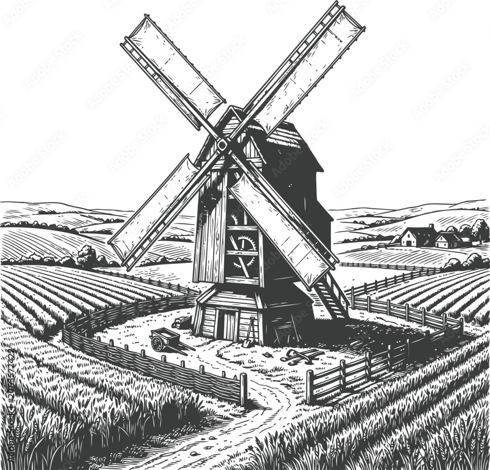 Fototapeta premium Vintage windmill with rotating blades in a rural landscape during daylight with cultivated fields and distant houses