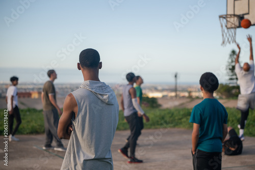 Spectators watching basketball match