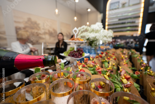 Fotografie Pouring sparkling beverage at catered celebration event.