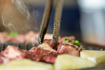 korean barbecue ingredients being cooked on charcoal grill pan