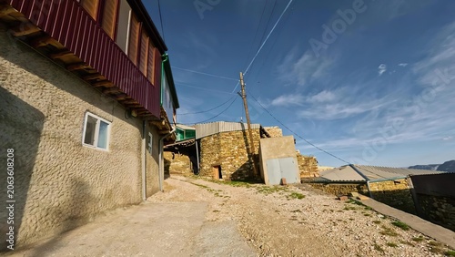 Fotografi Colorful houses on a hillside under a bright blue sky