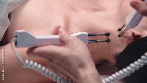 Doctor using ultrasound device on patient's chest during examination