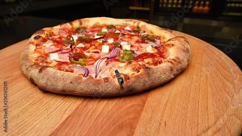 Fresh pizza with vegetables and cheese on wooden board