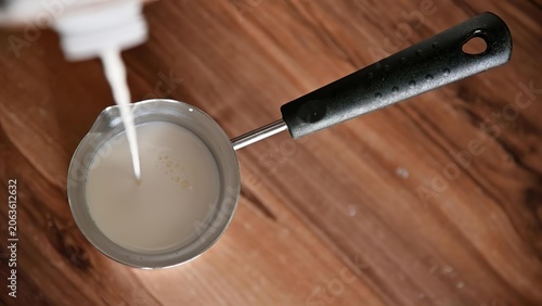 Frying pan with batter on a wooden kitchen counter