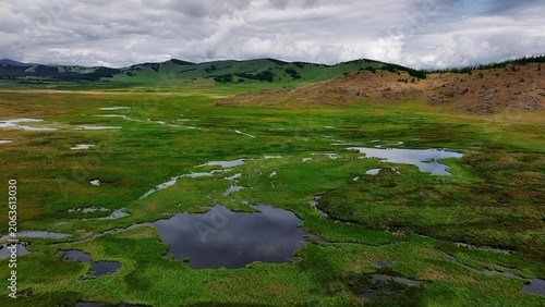 Green rolling hills and small lakes in a countryside landscape
