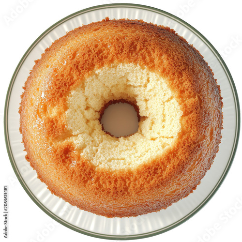 Golden angel food cake with a delicate crust on a glass plate isolated on white background