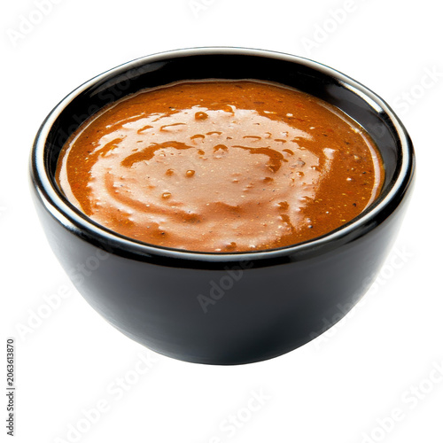 Rich brown sauce in a glossy black bowl isolated on white background