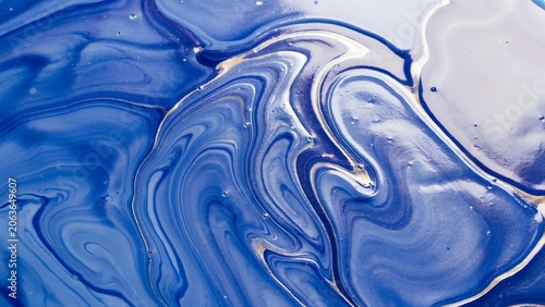 Blue and white swirling liquid with gold accents and a marbled effect