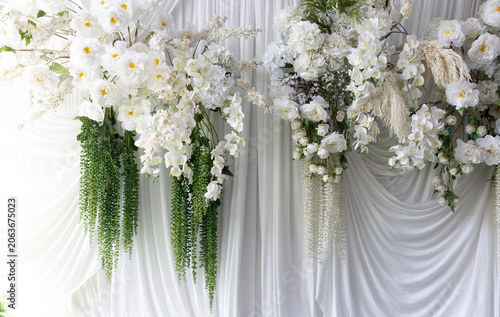 Beautiful white flowers decorate the background of white curtains.