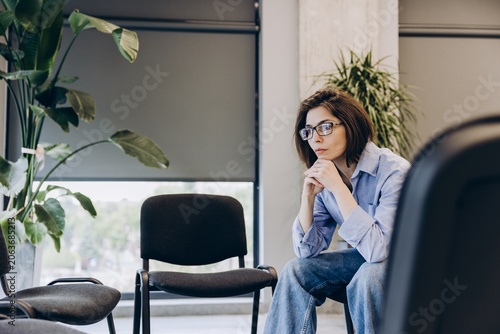 Fotografi Sad upset woman thinking, waiting in office hallway before meeting